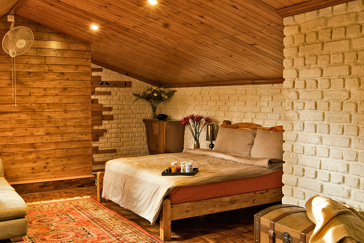 Cozy bedroom with wooden accents and white brick walls